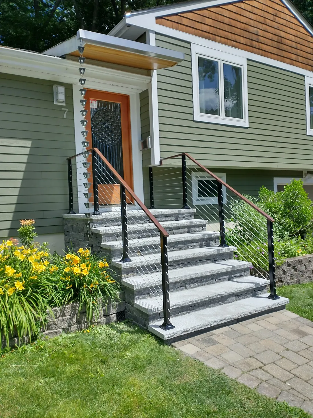Cable railing with wood cap on granite front steps, installed by MetalArt