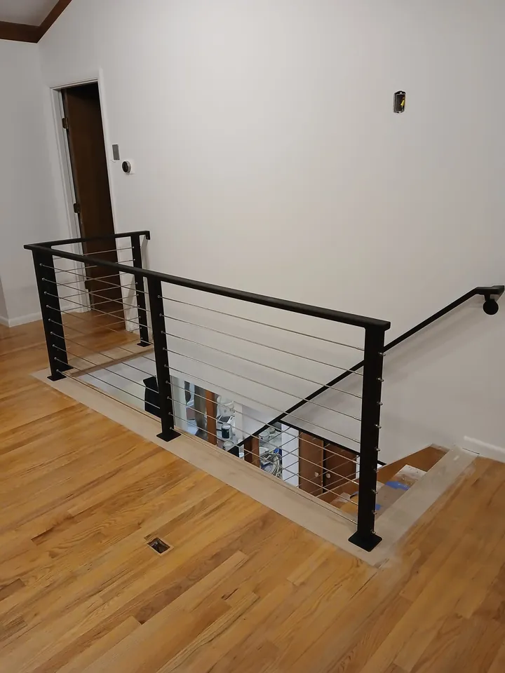 Stainless steel cable railing around an interior stairwell